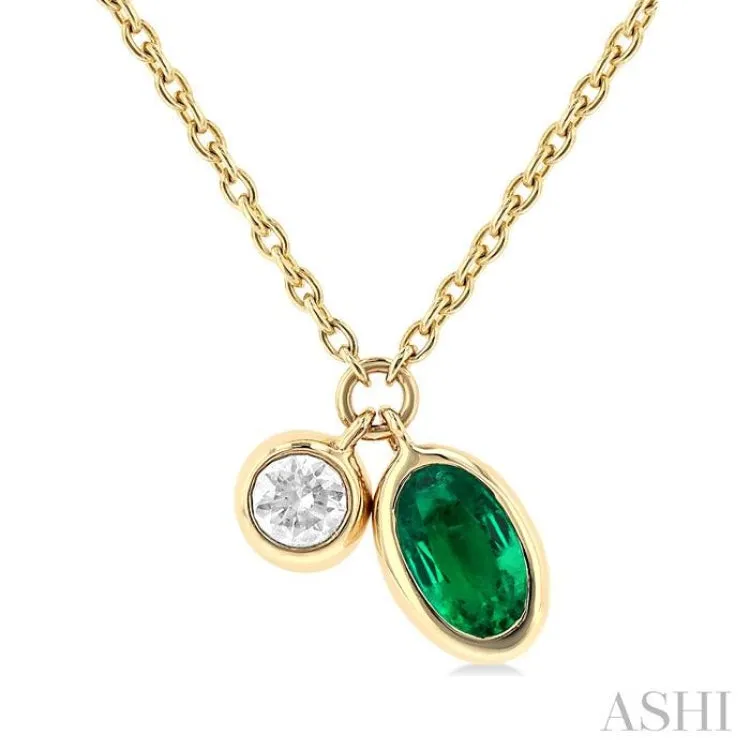 1/50 ctw Oval Cut 5X3MM Emerald and Bezel Set Round Cut Diamond Precious Necklace in 10K Yellow Gold